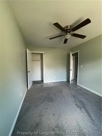a view of a livingroom with a ceiling fan and window