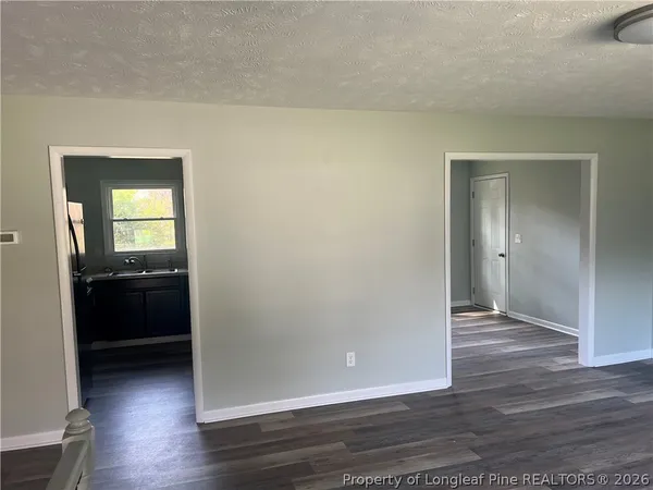 a view of a kitchen from the hallway with a kitchen