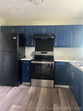 a kitchen with a refrigerator and a sink