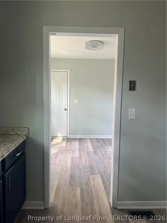 a view of a hallway with wooden floor
