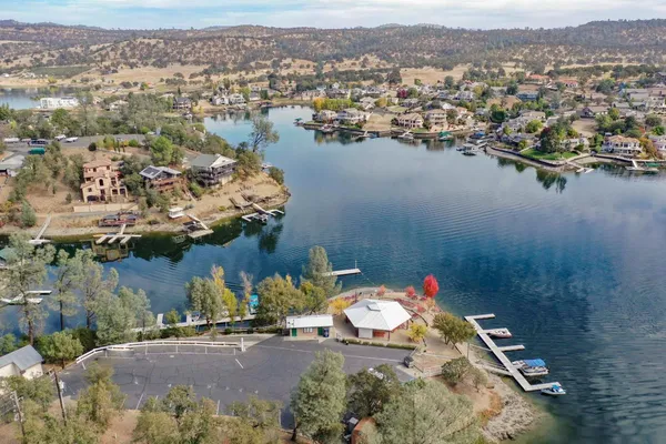 a view of a house with a yard and lake view