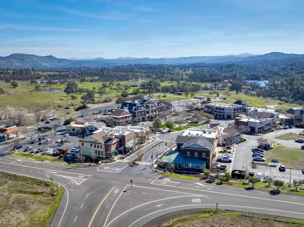 an aerial view of residential houses and lake view