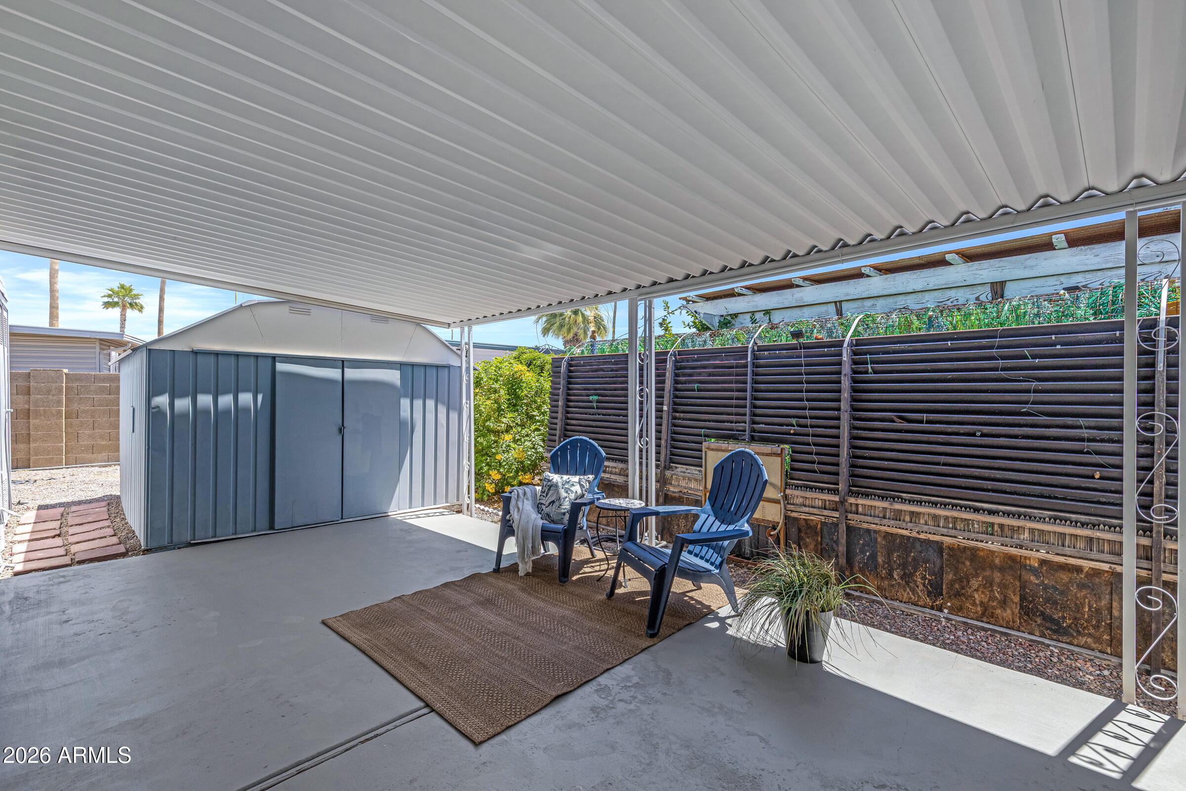 201 South Greenfield Road, Unit 269 Mesa, AZ 85206 - Photo 14 of 18 a view of a patio with a table and chairs and potted plants
