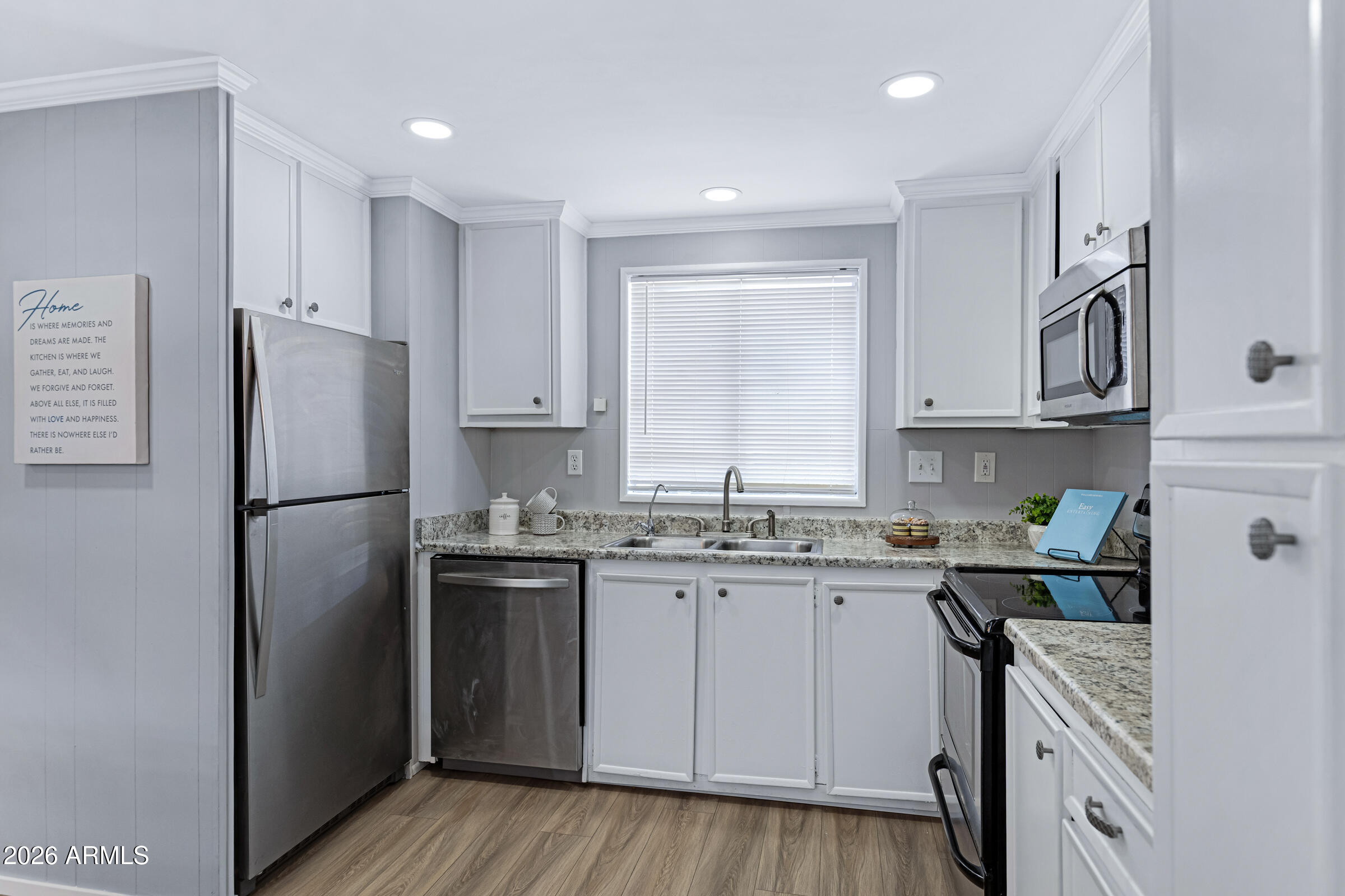 201 South Greenfield Road, Unit 269 Mesa, AZ 85206 - Photo 6 of 18 a kitchen with stainless steel appliances granite countertop a refrigerator sink and cabinets