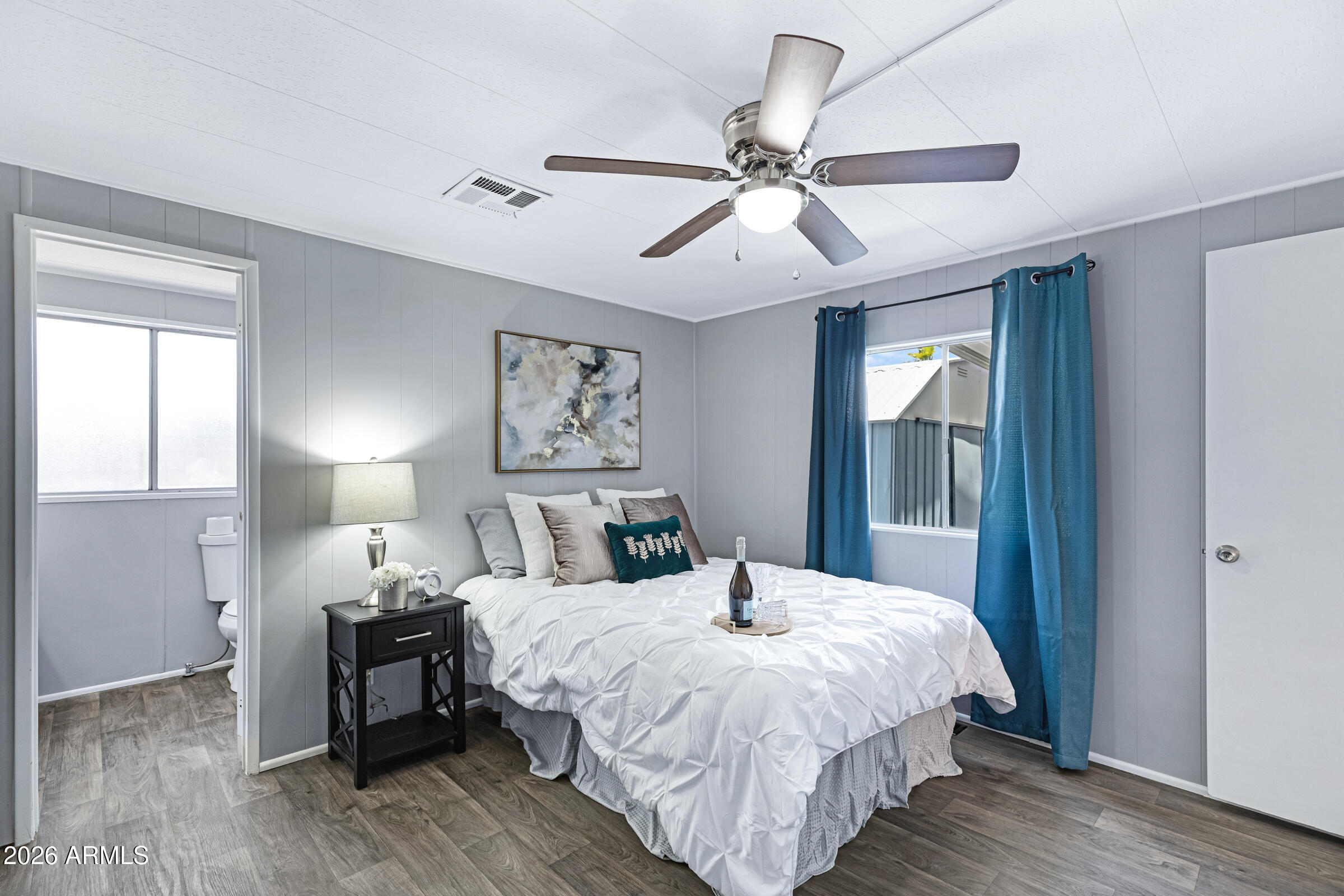 201 South Greenfield Road, Unit 269 Mesa, AZ 85206 - Photo 7 of 18 a bedroom with a bed and wooden floor