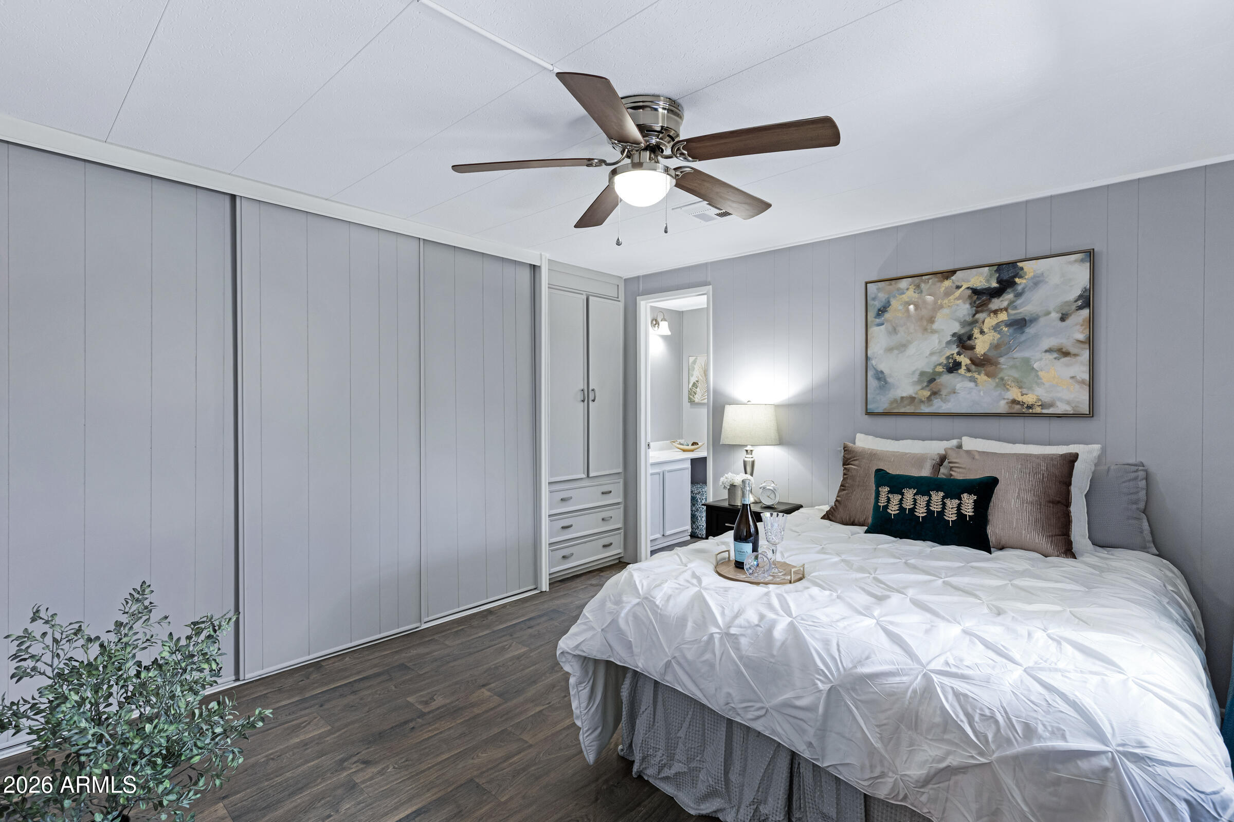 201 South Greenfield Road, Unit 269 Mesa, AZ 85206 - Photo 8 of 18 a bedroom with a large bed and a chandelier