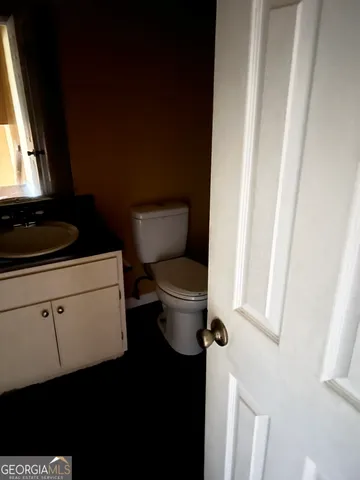 a bathroom with a toilet and a sink