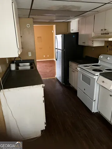 a kitchen with a refrigerator and a stove
