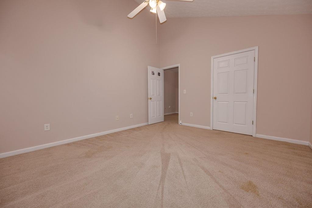 6280 Lake Valley Point Lithonia, GA 30058 - Photo 12 of 30 a view of an empty room and a chandelier fan