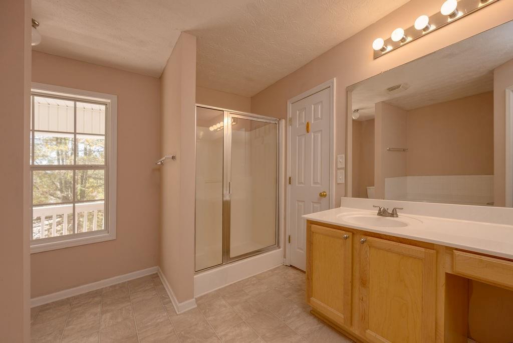 6280 Lake Valley Point Lithonia, GA 30058 - Photo 20 of 30 a bathroom with a sink vanity granite tub and shower