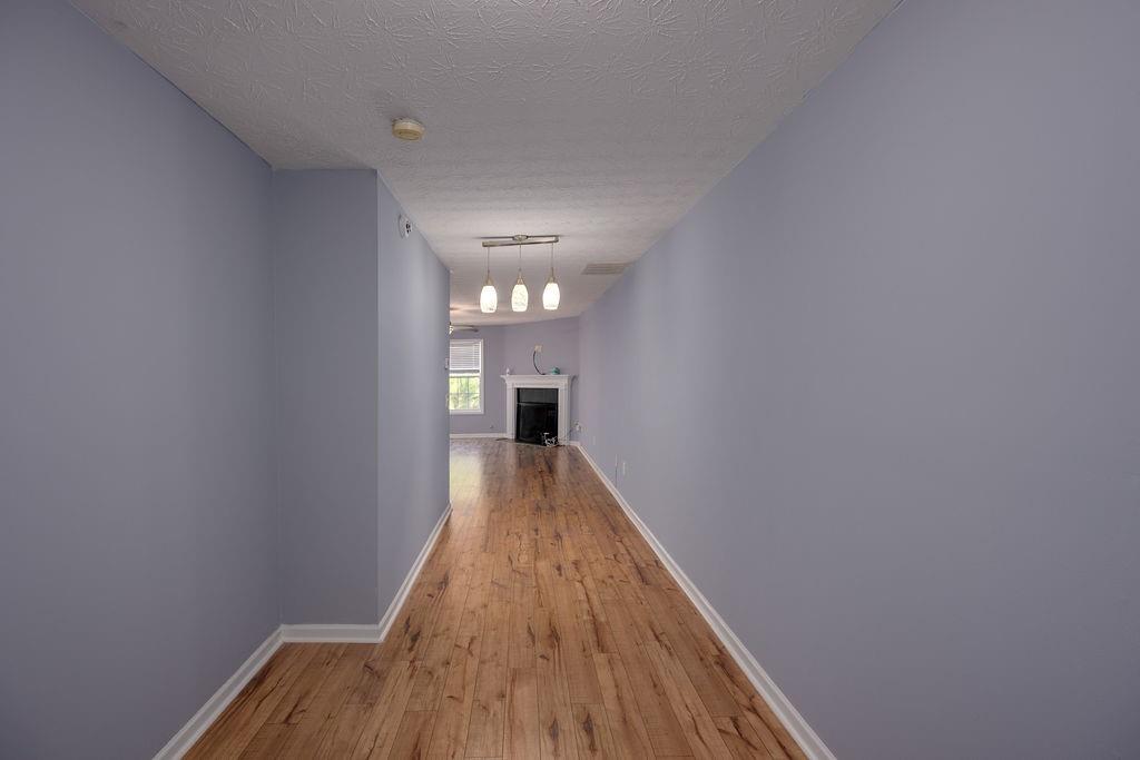 6280 Lake Valley Point Lithonia, GA 30058 - Photo 3 of 30 a view of a hallway with wooden floor and staircase