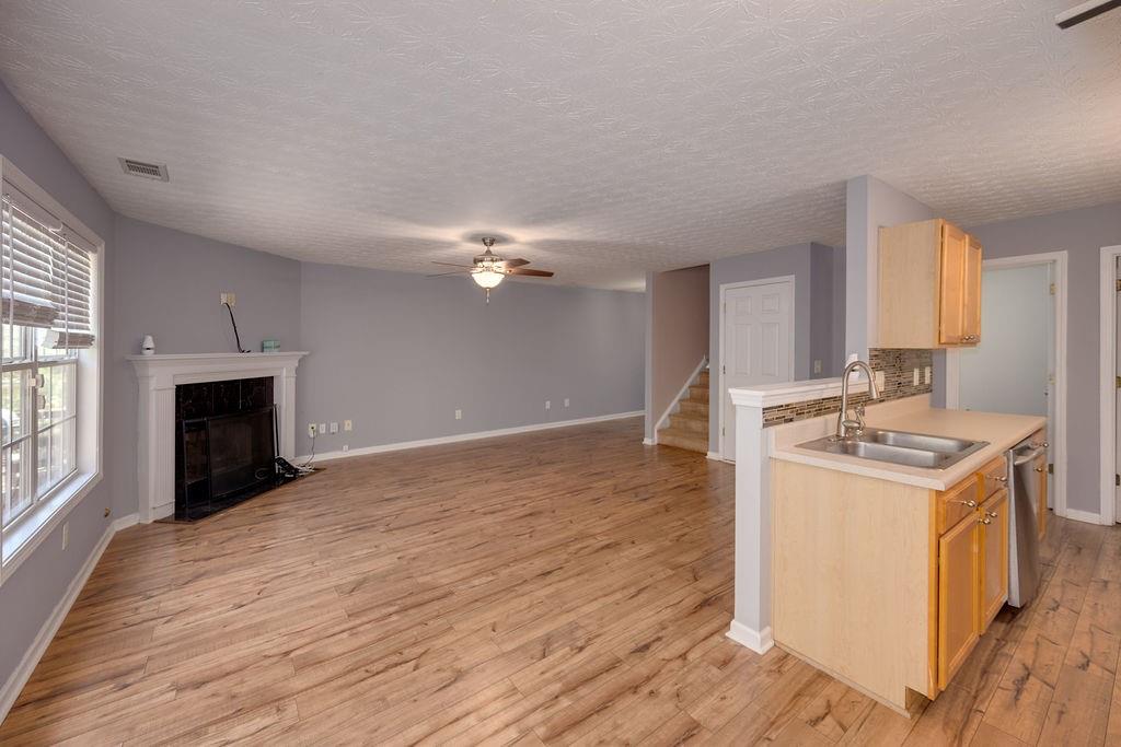 6280 Lake Valley Point Lithonia, GA 30058 - Photo 4 of 30 an empty room with kitchen appliances and wooden floor