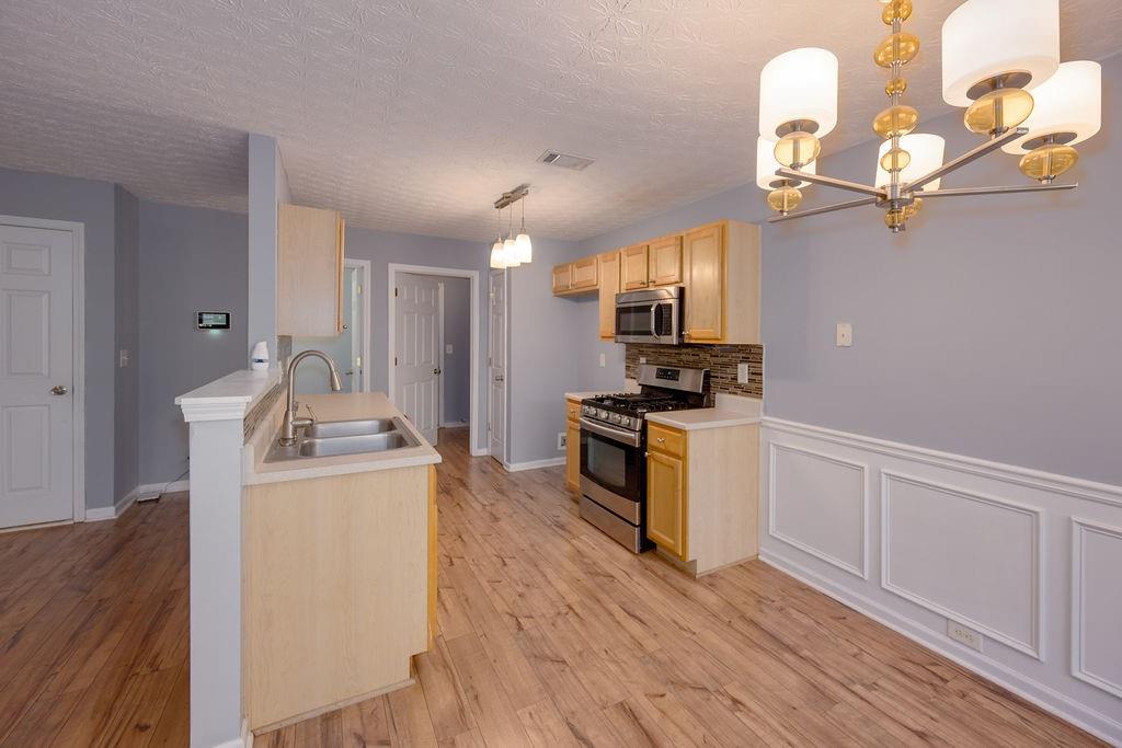 6280 Lake Valley Point Lithonia, GA 30058 - Photo 5 of 30 a kitchen with sink a microwave and cabinets