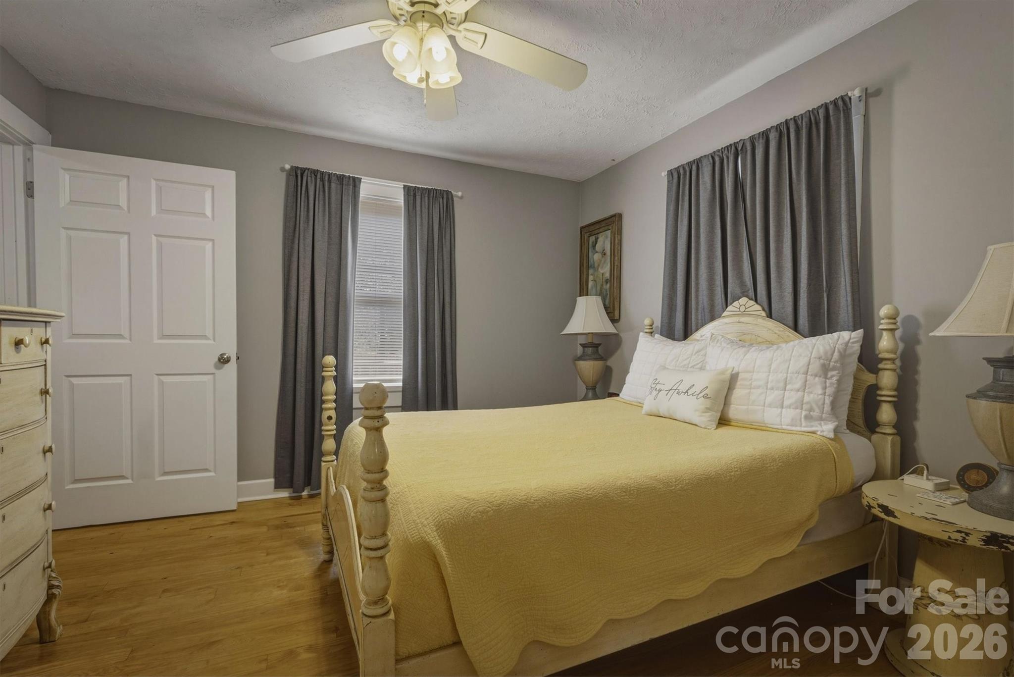 905 Carbon City Road Morganton, NC 28655 - Photo 21 of 29 a bedroom with a bed and a chandelier