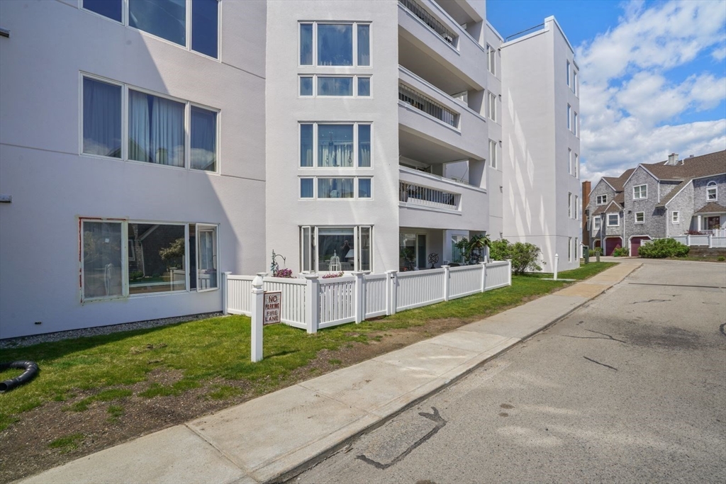 1 Commodore Court, Unit 104 Hull, MA 02045 - Photo 29 of 35 a view of building with yard in front of it