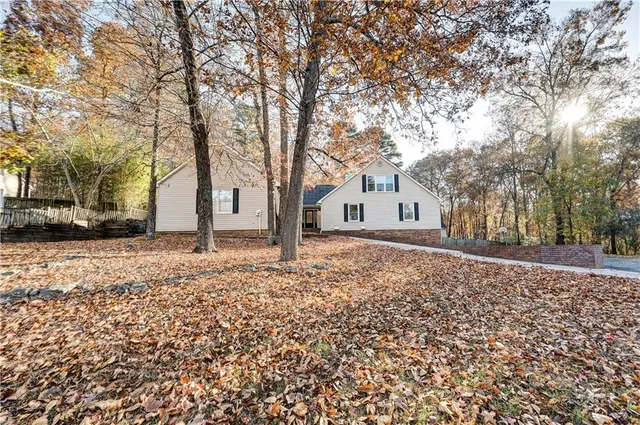 a view of a house with a yard covered in snow