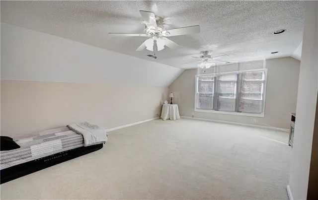 a view of a livingroom with lounge chair and a window