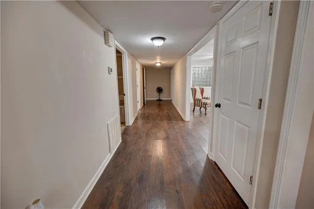an aerial view of residential houses with outdoor space and trees