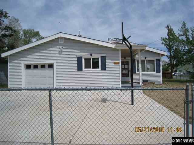 1975 Castle Way Reno, NV 89512 - Photo 1 of 6 a front view of a house with a yard