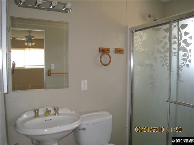 1975 Castle Way Reno, NV 89512 - Photo 5 of 6 a bathroom with a sink a toilet and a mirror