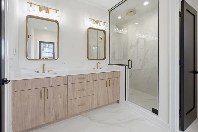 a bathroom with double sink and a mirror