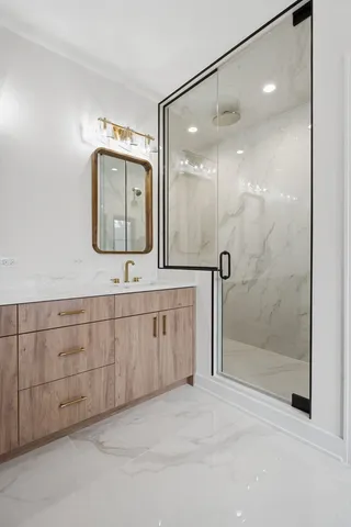 a bathroom with a double vanity sink mirror and shower