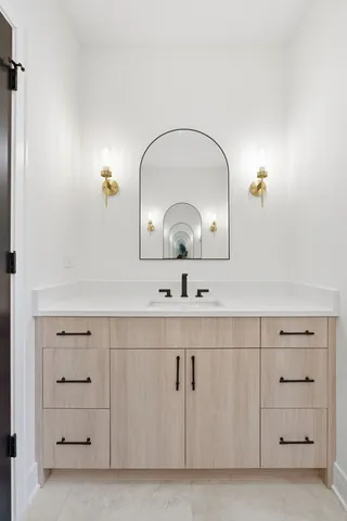 a bathroom with a sink mirror and vanity