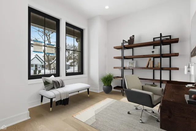a living room with furniture floor to ceiling window and a flat screen tv