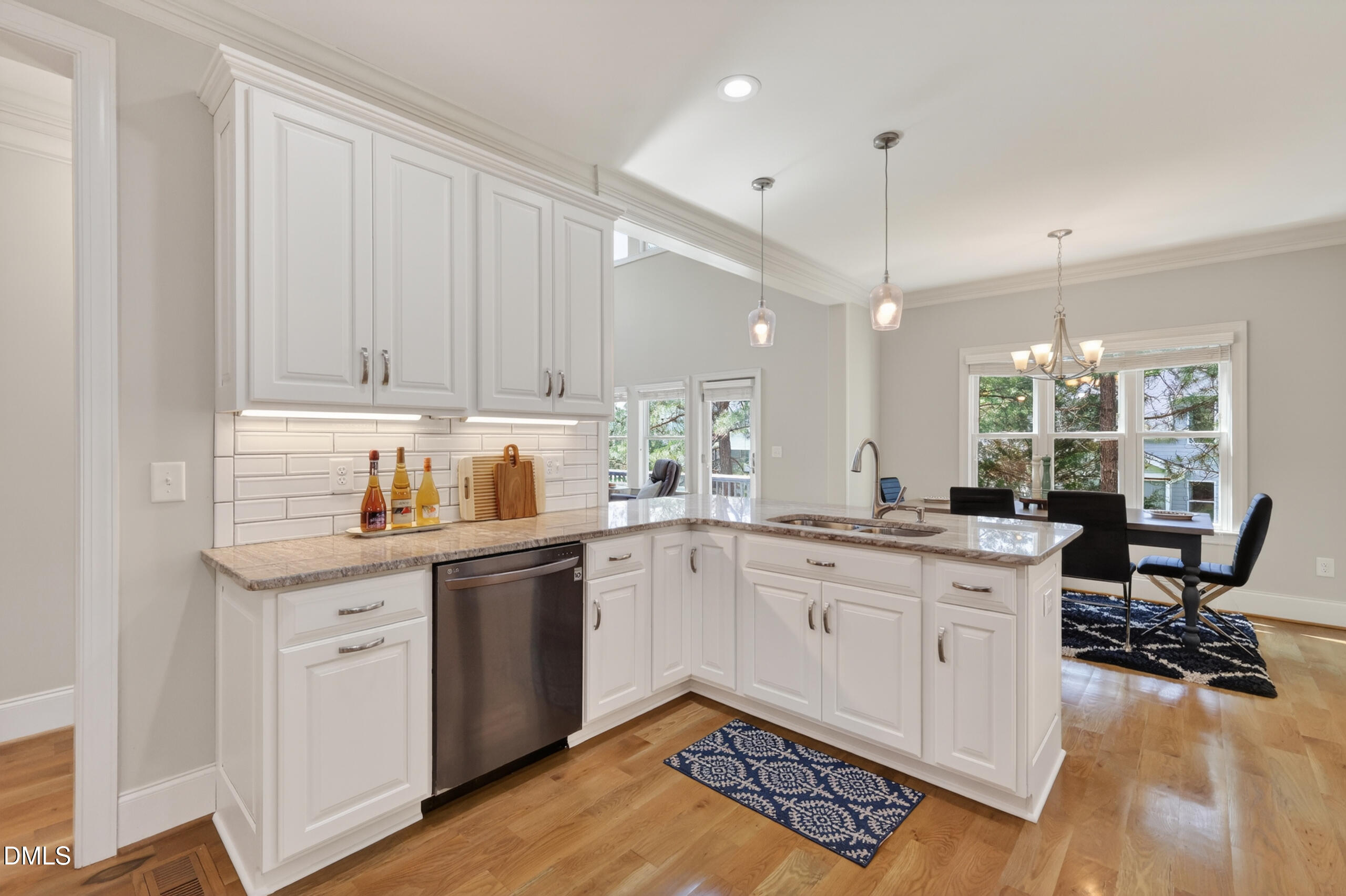261 Character Drive Rolesville, NC 27571 - Photo 19 of 77 a kitchen with a sink cabinets and wooden floor