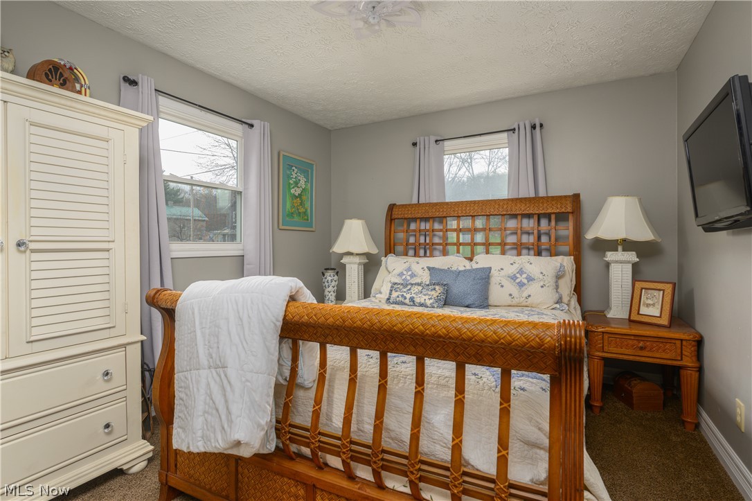 390 Ross Road Waynesburg, OH 44688 - Photo 12 of 30 Carpeted bedroom with a textured ceiling and multiple windows