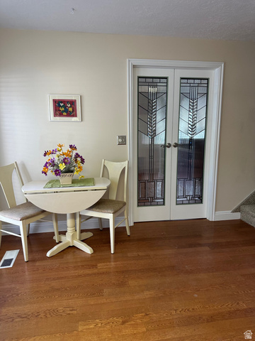 254 Meadow Lane Centerville, UT 84014 - Photo 13 of 34 French doors with decorative glass panels, wood-finish flooring, and white trim accents