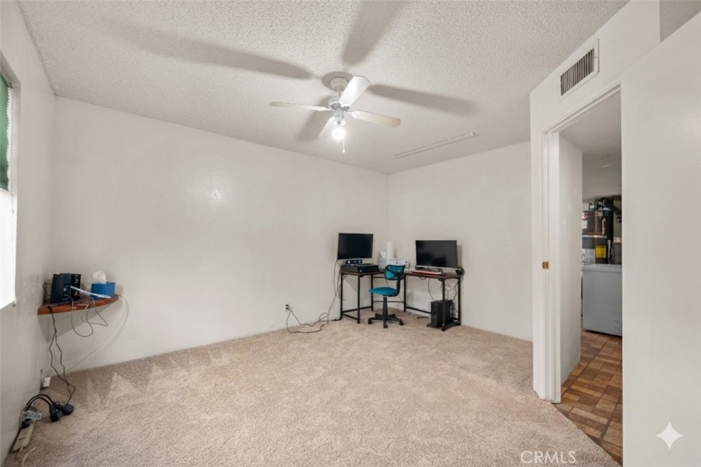 30602 San Martinez Road Val Verde, CA 91384 - Photo 11 of 47 a view of a workspace with furniture and a window