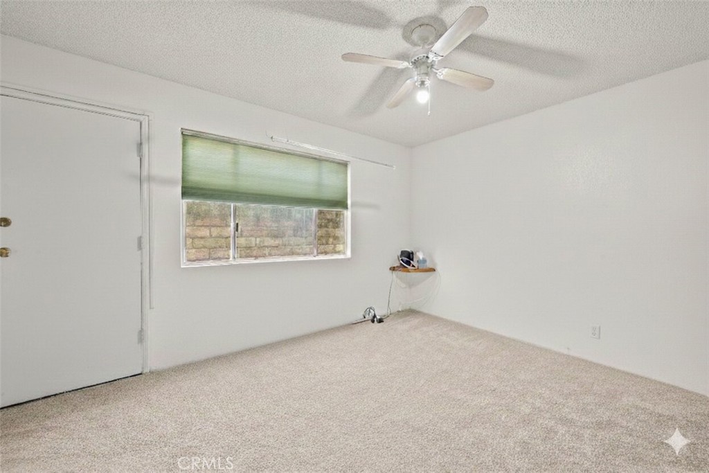 30602 San Martinez Road Val Verde, CA 91384 - Photo 12 of 47 an empty room with windows and fan