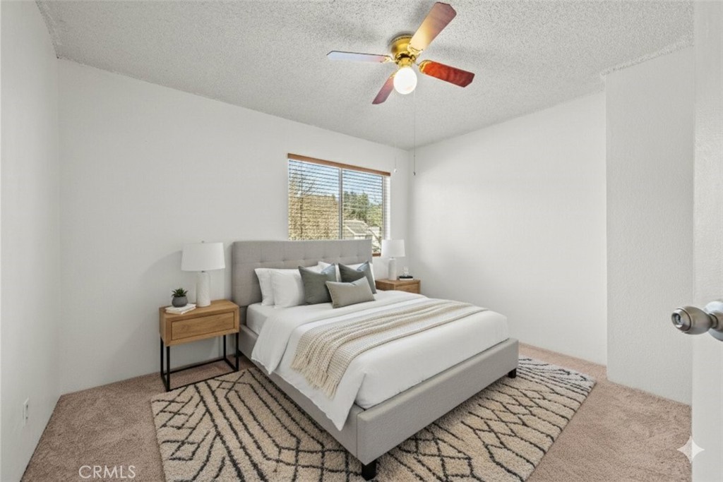 30602 San Martinez Road Val Verde, CA 91384 - Photo 16 of 47 a bedroom with a bed and a chandelier