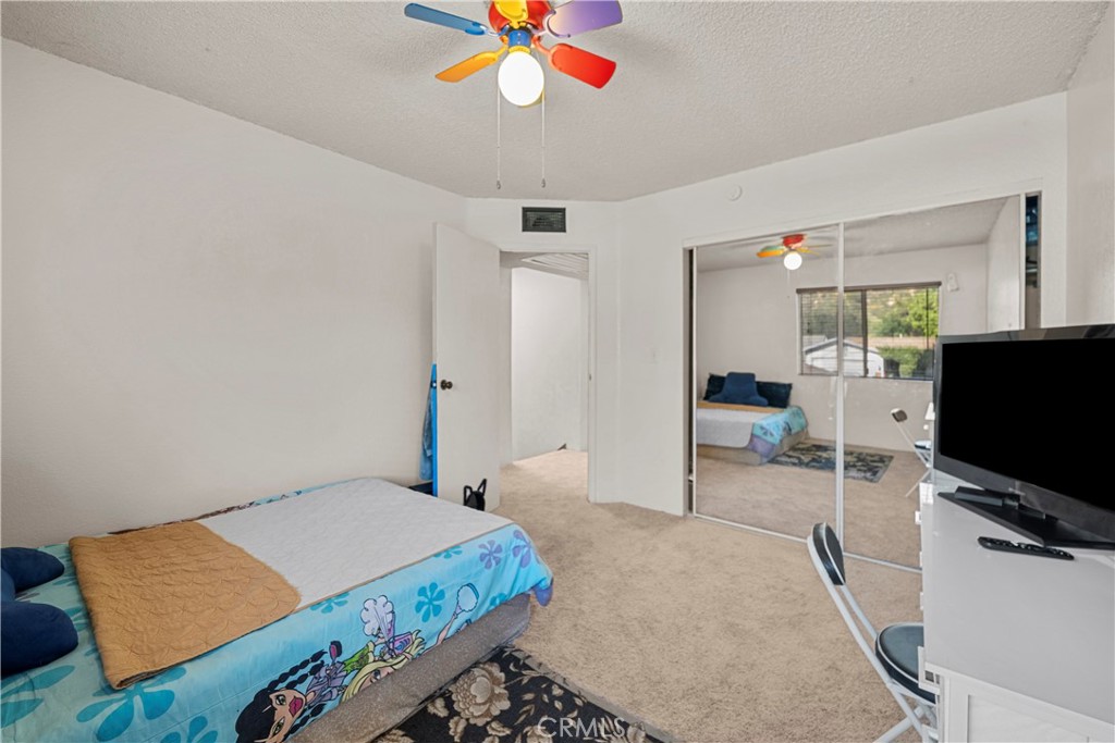 30602 San Martinez Road Val Verde, CA 91384 - Photo 19 of 47 a bedroom with a bed and a flat screen tv