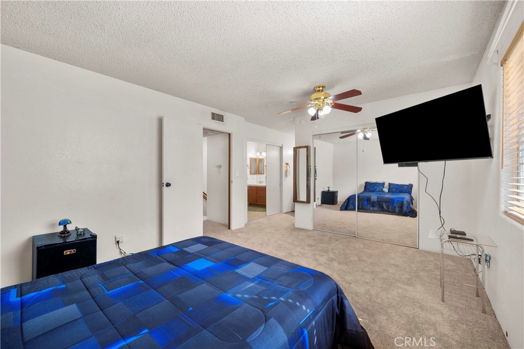 30602 San Martinez Road Val Verde, CA 91384 - Photo 21 of 47 a bedroom with a bed and a flat screen tv