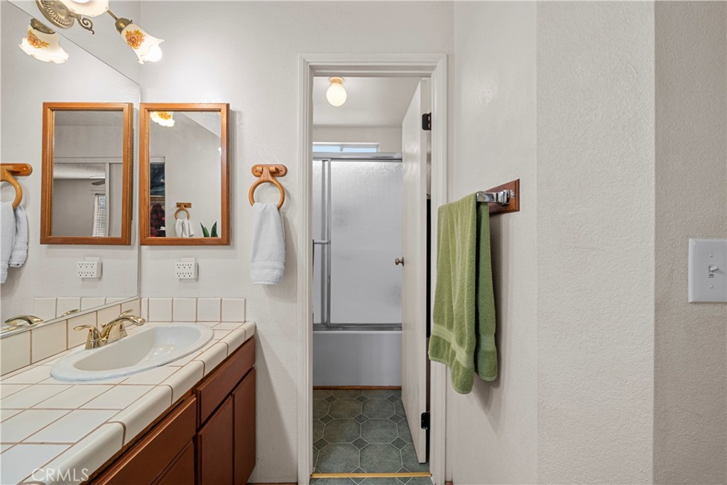 30602 San Martinez Road Val Verde, CA 91384 - Photo 24 of 47 a bathroom with a granite countertop sink and a mirror