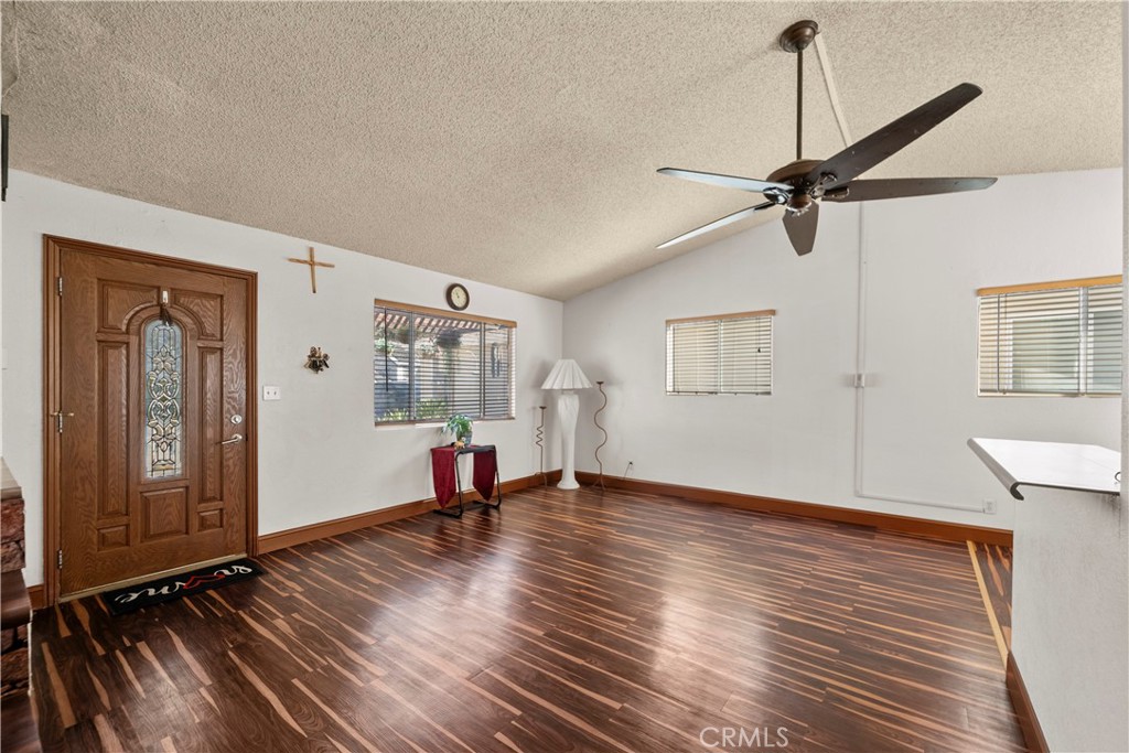 30602 San Martinez Road Val Verde, CA 91384 - Photo 3 of 47 a view of an empty room with a window and wooden floor