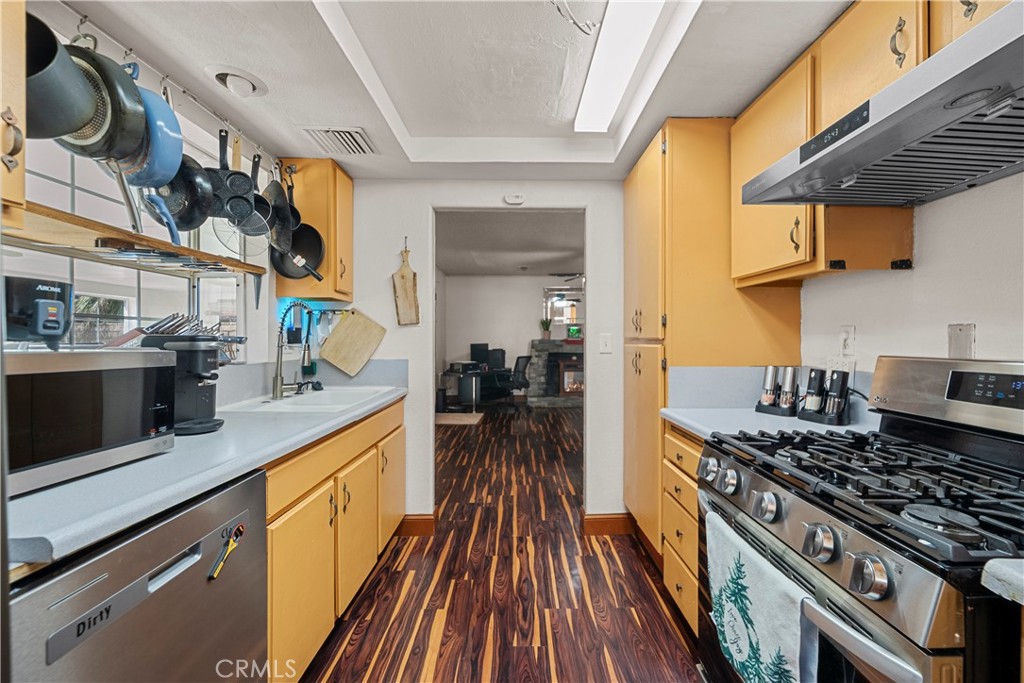 30602 San Martinez Road Val Verde, CA 91384 - Photo 7 of 47 a kitchen with stainless steel appliances granite countertop a stove and a wooden floors