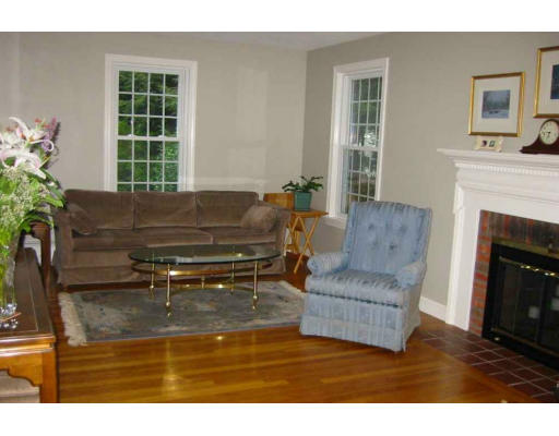 11 James Road Reading, MA 01867 - Photo 3 of 9 a living room with furniture and a fireplace