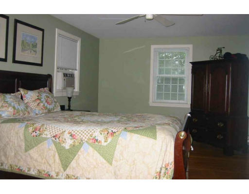 11 James Road Reading, MA 01867 - Photo 7 of 9 a bed sitting in a bedroom next to a window