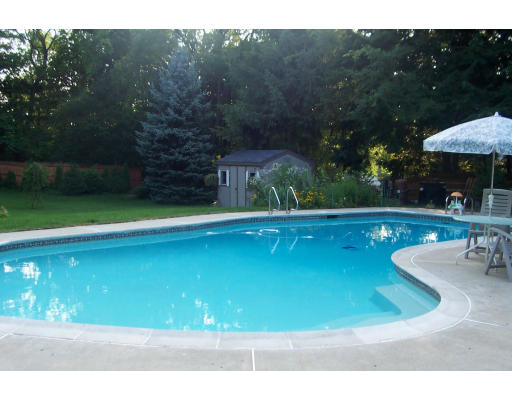 11 James Road Reading, MA 01867 - Photo 8 of 9 a view of a swimming pool with a yard