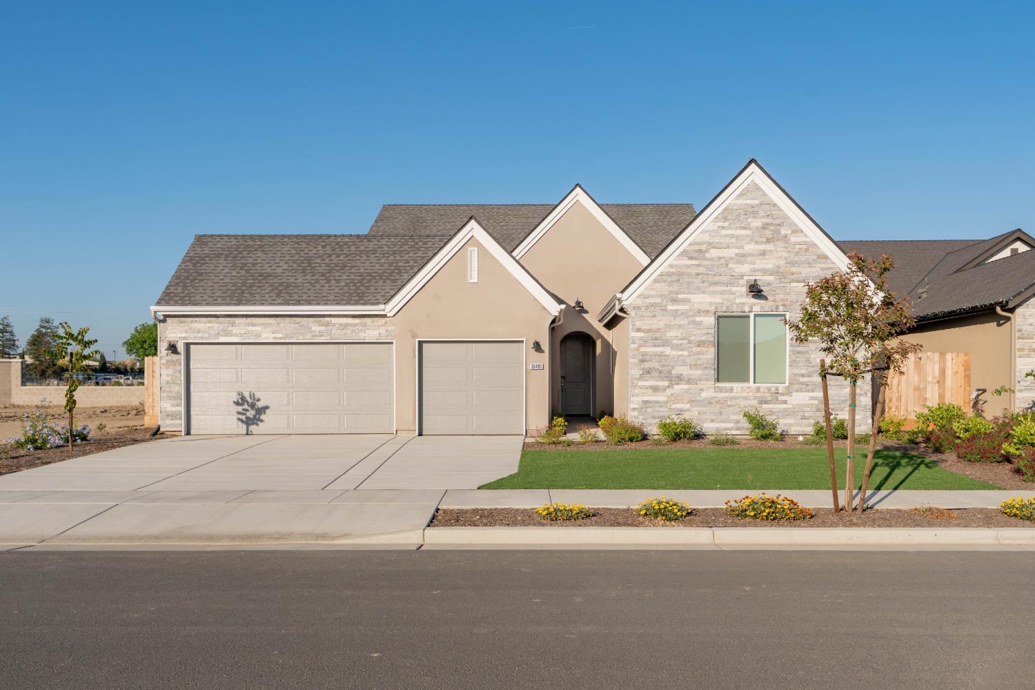 30480 Bellwood Road Visalia, CA 93291 - Photo 1 of 37 a front view of a house with a yard and garage