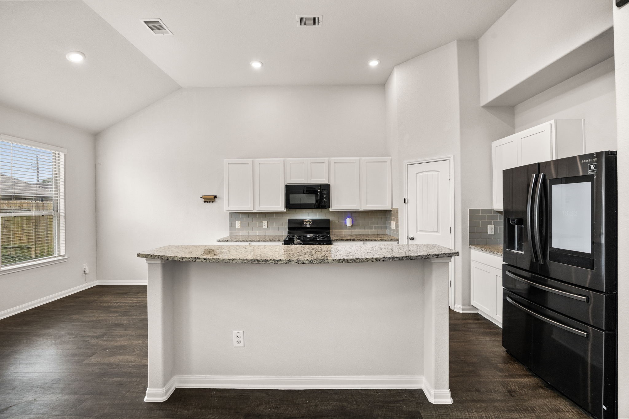15731 Ty Cobb Court Splendora, TX 77372 - Photo 15 of 36 a kitchen with stainless steel appliances a sink stove refrigerator and cabinets