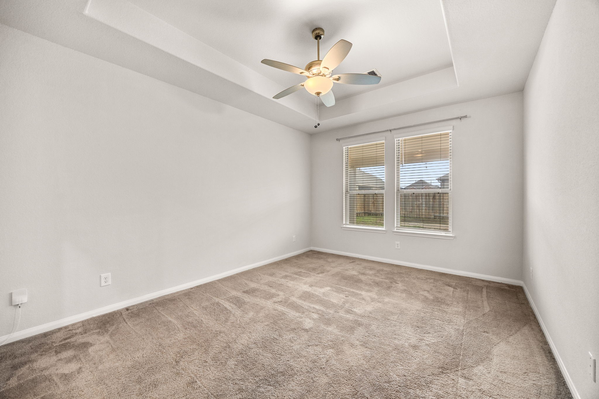 15731 Ty Cobb Court Splendora, TX 77372 - Photo 17 of 36 an empty room with a chandelier fan and windows