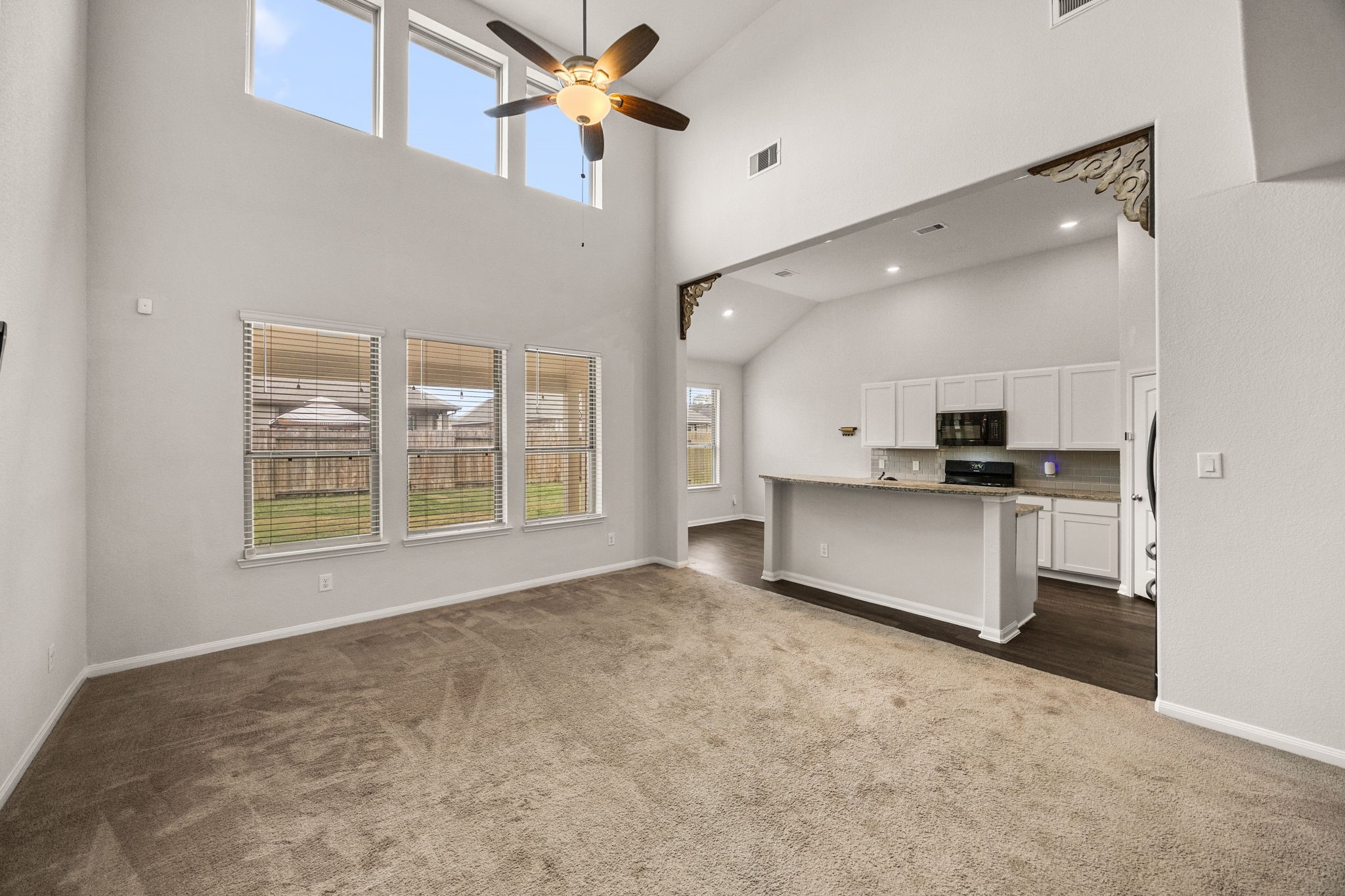 15731 Ty Cobb Court Splendora, TX 77372 - Photo 8 of 36 a view of kitchen and empty room with a kitchen