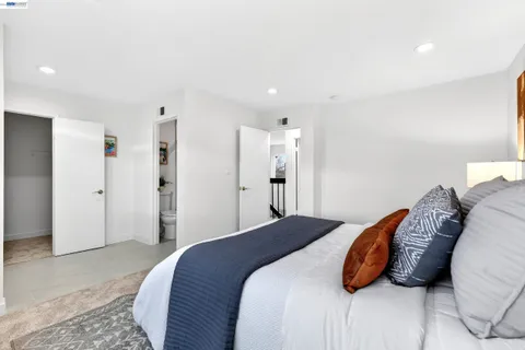 a bedroom with a bed and a chair