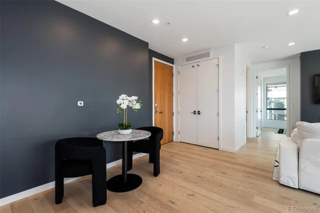 a view of a kitchen area with furniture and wooden floor