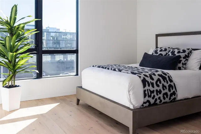 a bed sitting in a bedroom next to a window