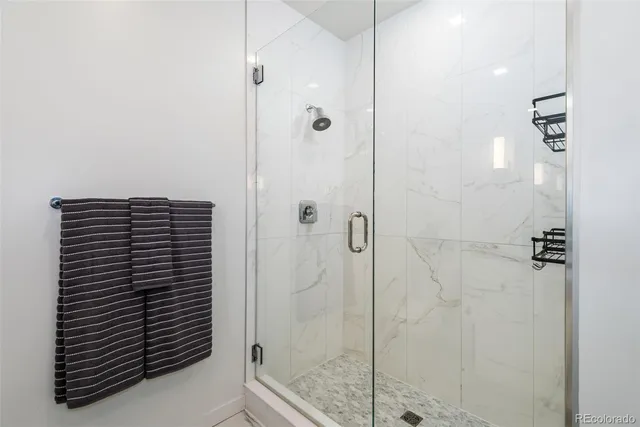 a bathroom with a shower and a sink